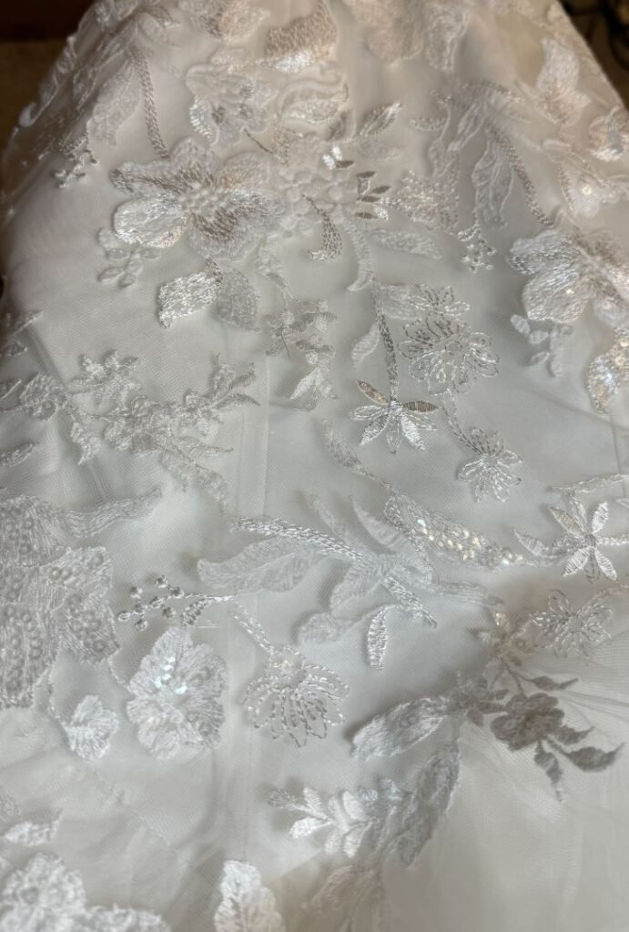 wedding dress lining, outer, and lace overlay layers taken in four inches showing how lace seam is invisible after alteration