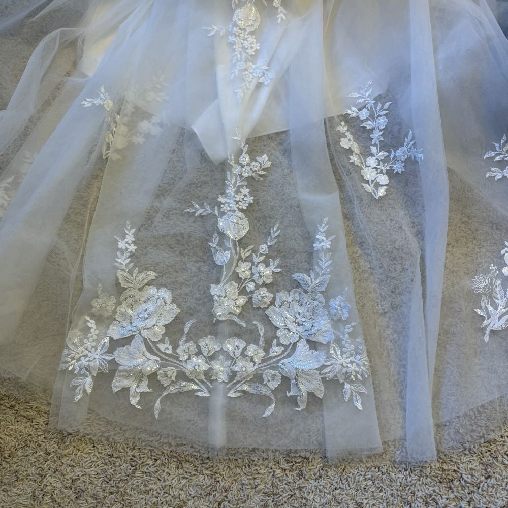 lace detail on wedding dress train reinforced so full lace motif lays full width when bustled