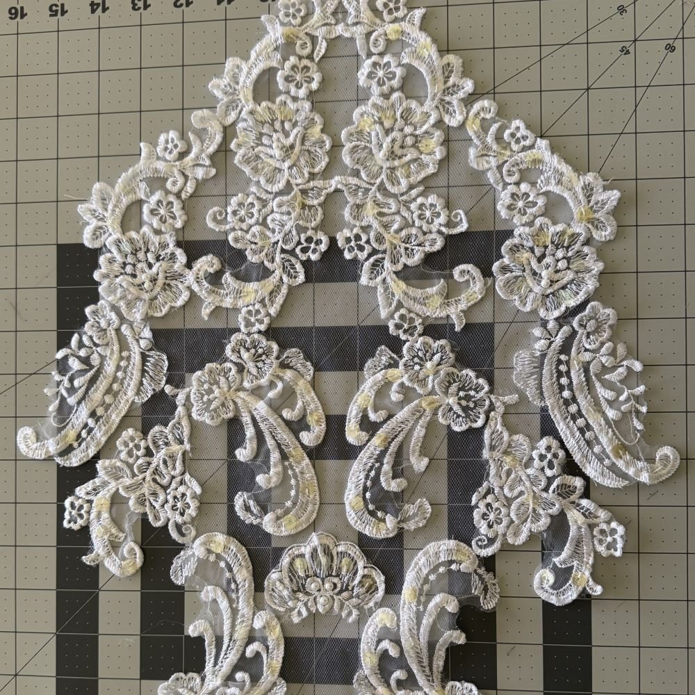 train lace applique removed from vintage wedding dress ready to be refashioned on bridal robe design